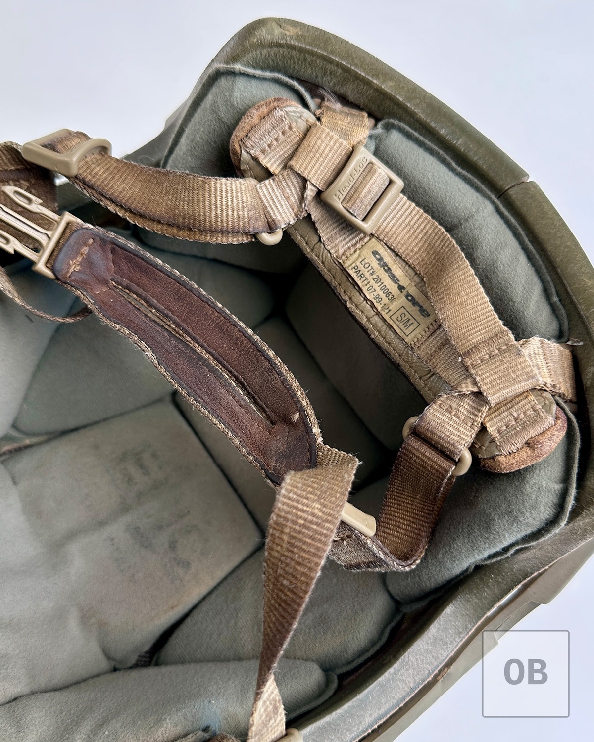 Original suspension and worn comfort pads inside ACH helmet.