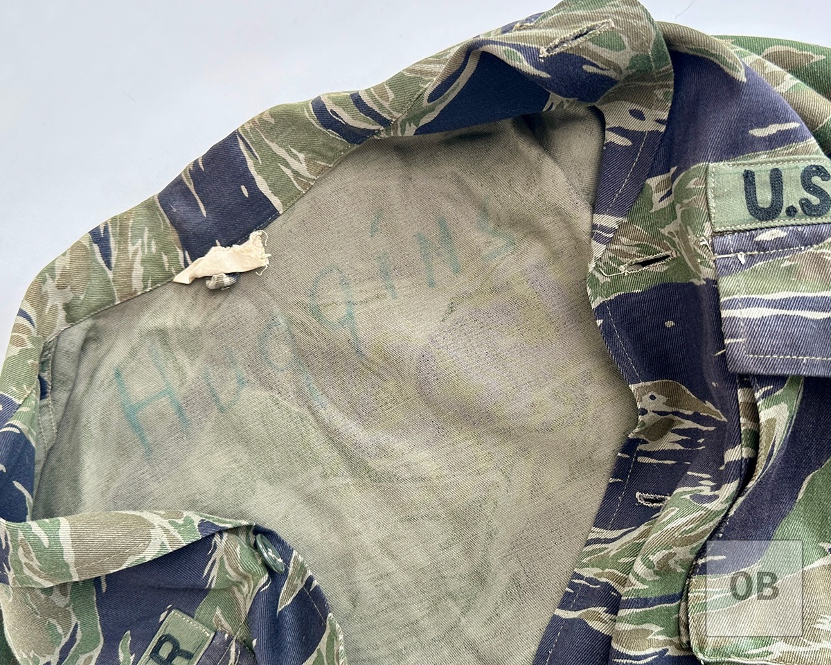Huggins's surname written in blue-green ink inside the jacket collar.