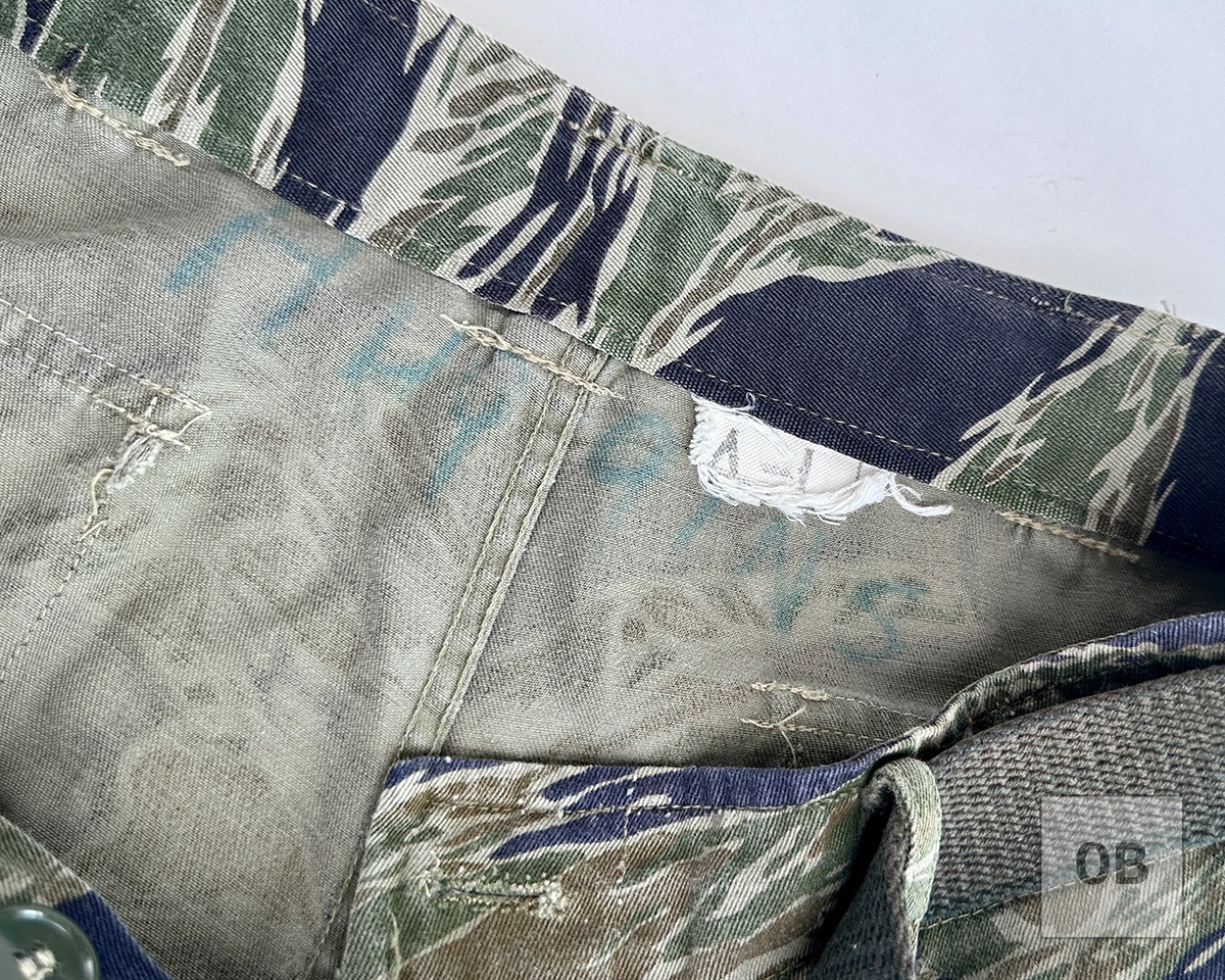 Huggins's name in faded ink lettering inside the trousers waistband.
