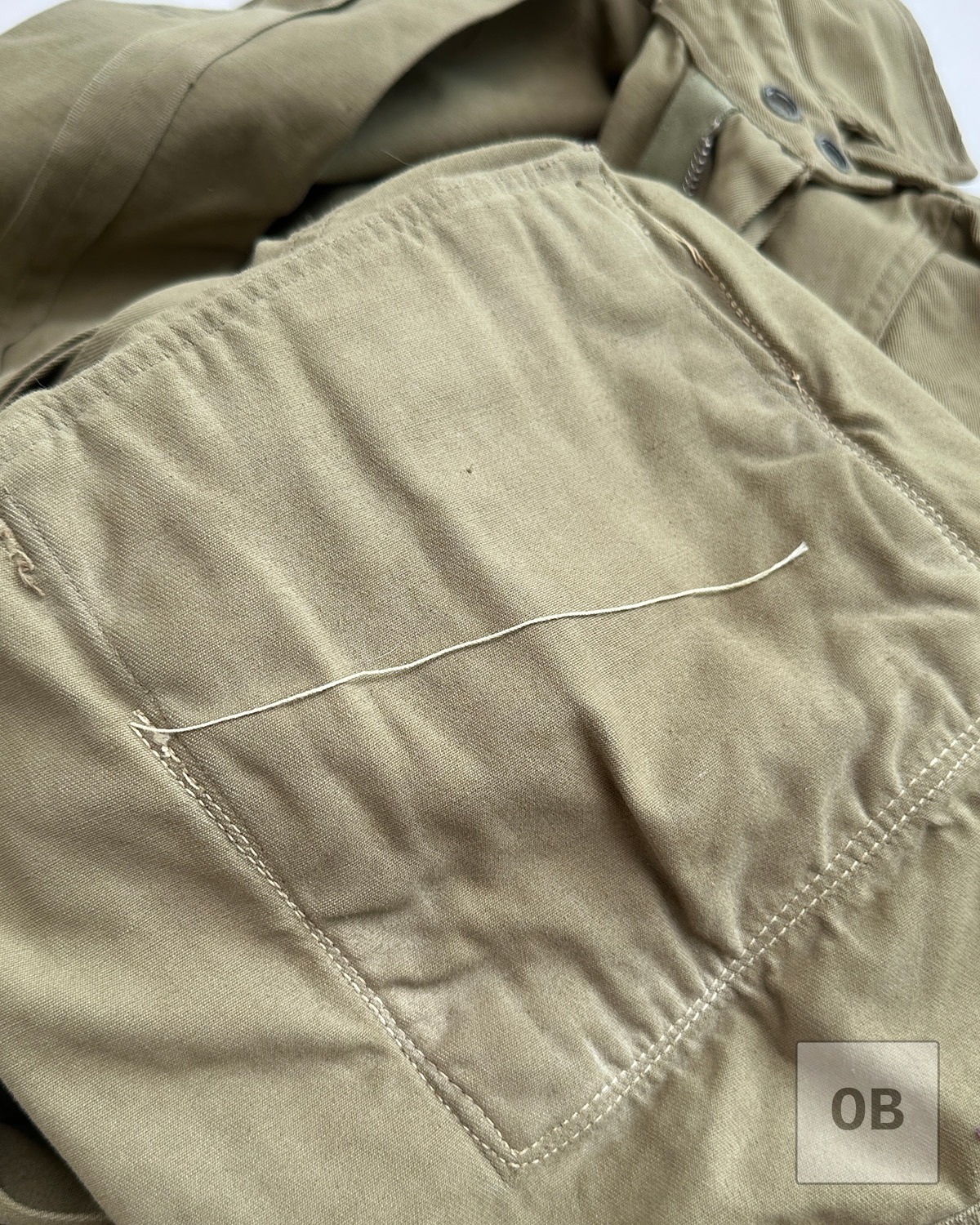 Untrimmed thread tails WWII M42 jump jacket airborne rigger reinforcement