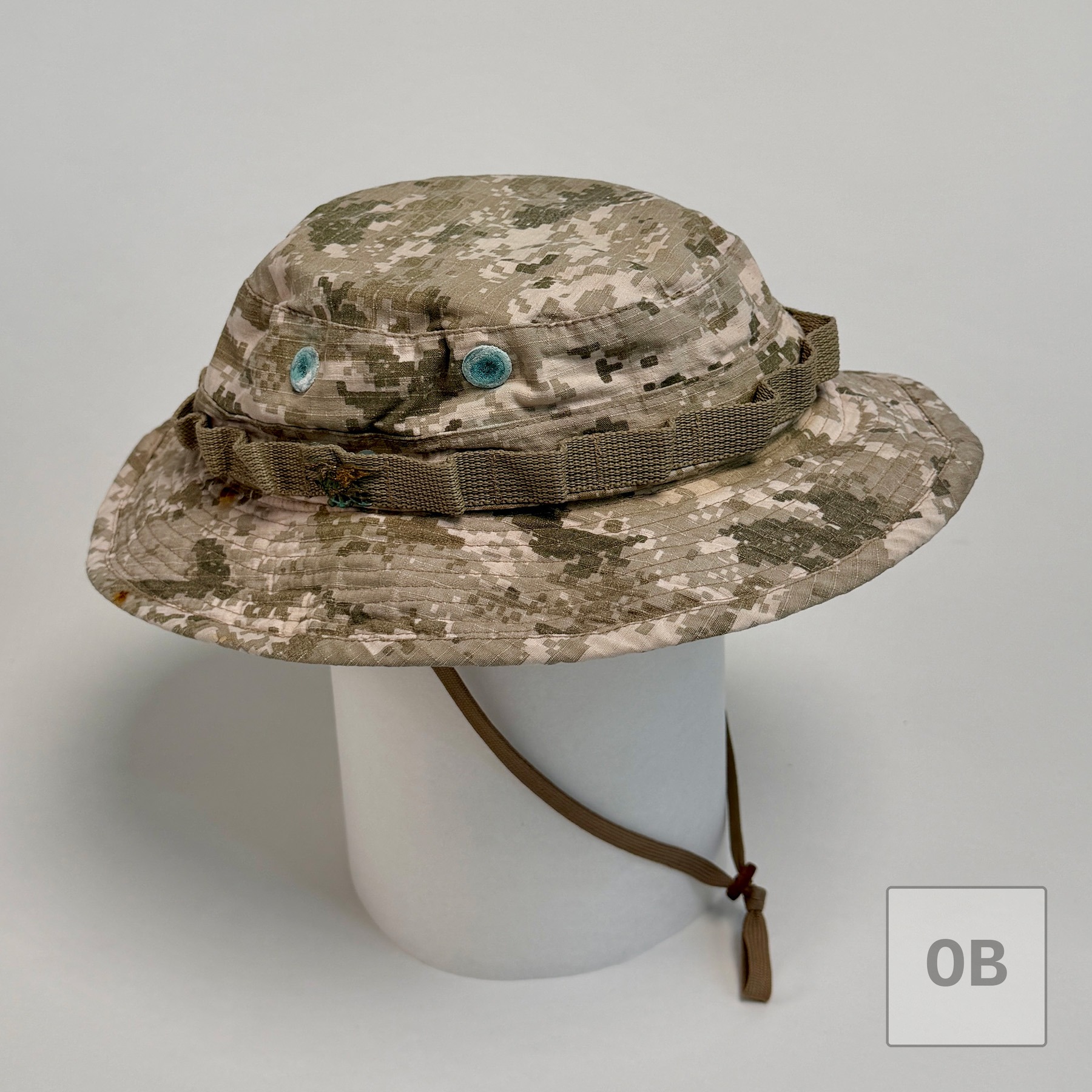 Side view of an AOR1 digital desert camouflage boonie hat on a display form.
