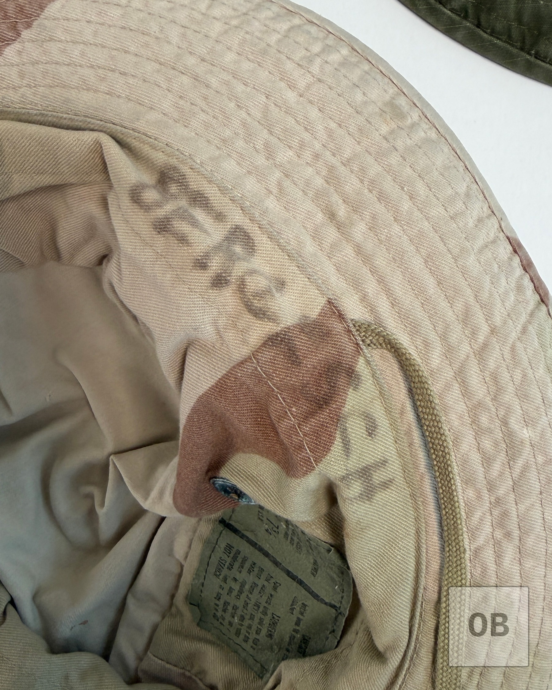 The same handwritten surname found on the other two hats, faded but still legible, written inside the three-color desert hat's crown above the interior label.