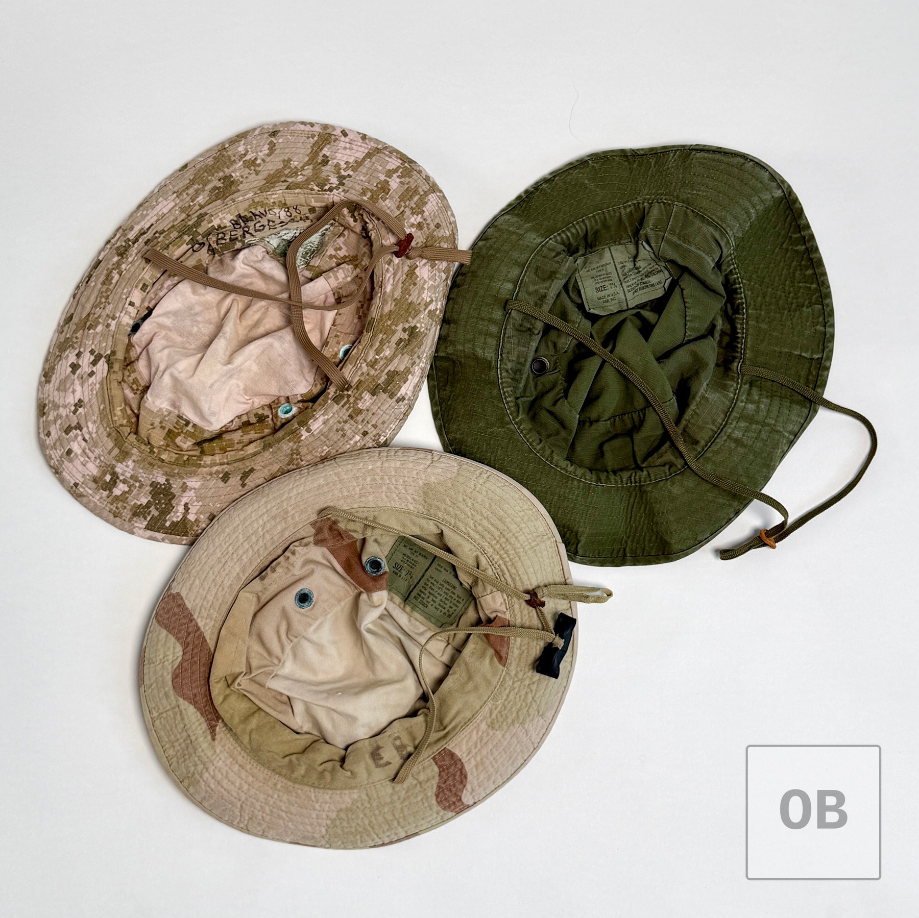 The same three boonie hats turned to show their interiors, sweatbands, and chin cords.