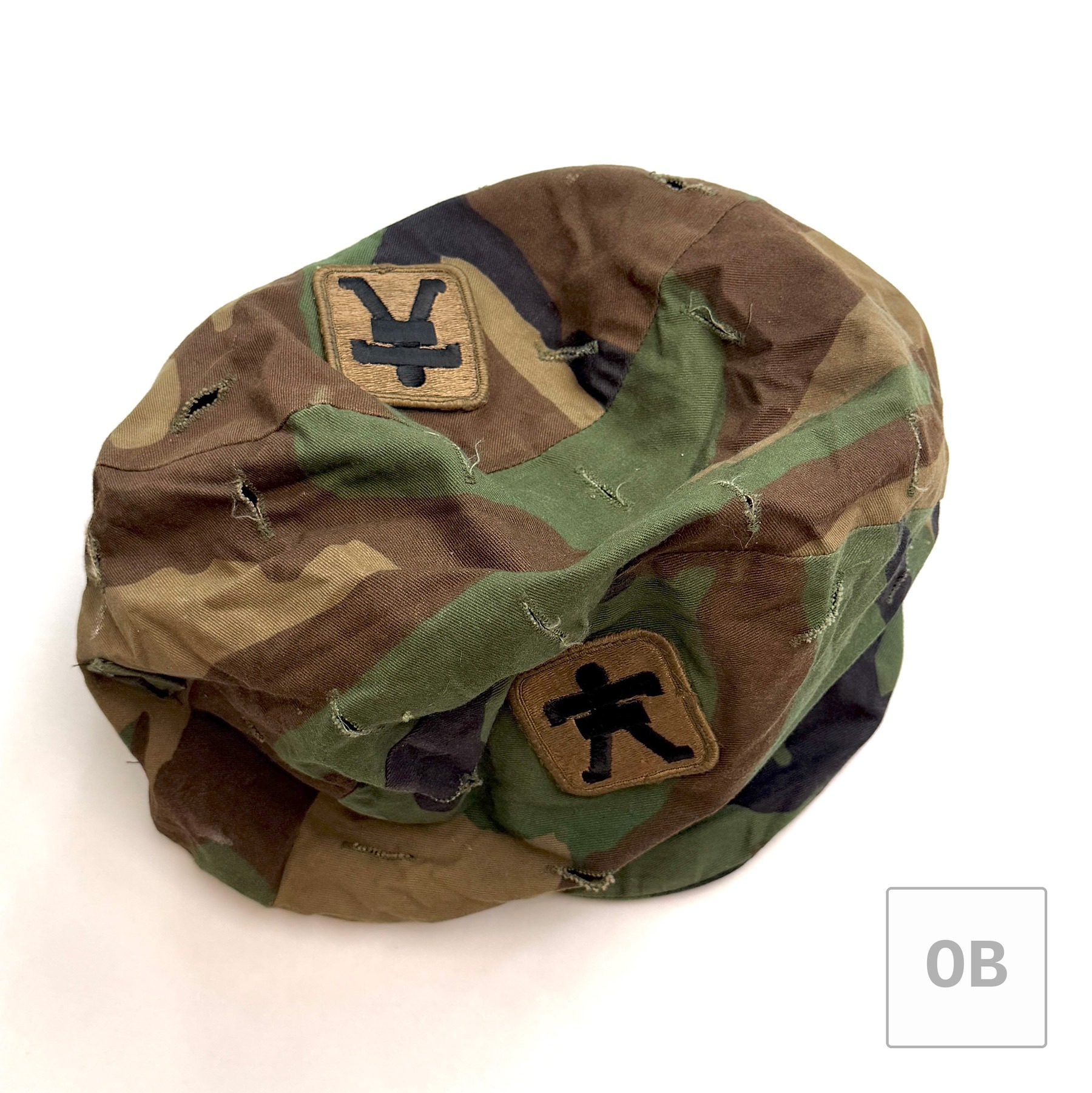 Woodland helmet cover associated with the 509th, worn prior to Special Forces selection.