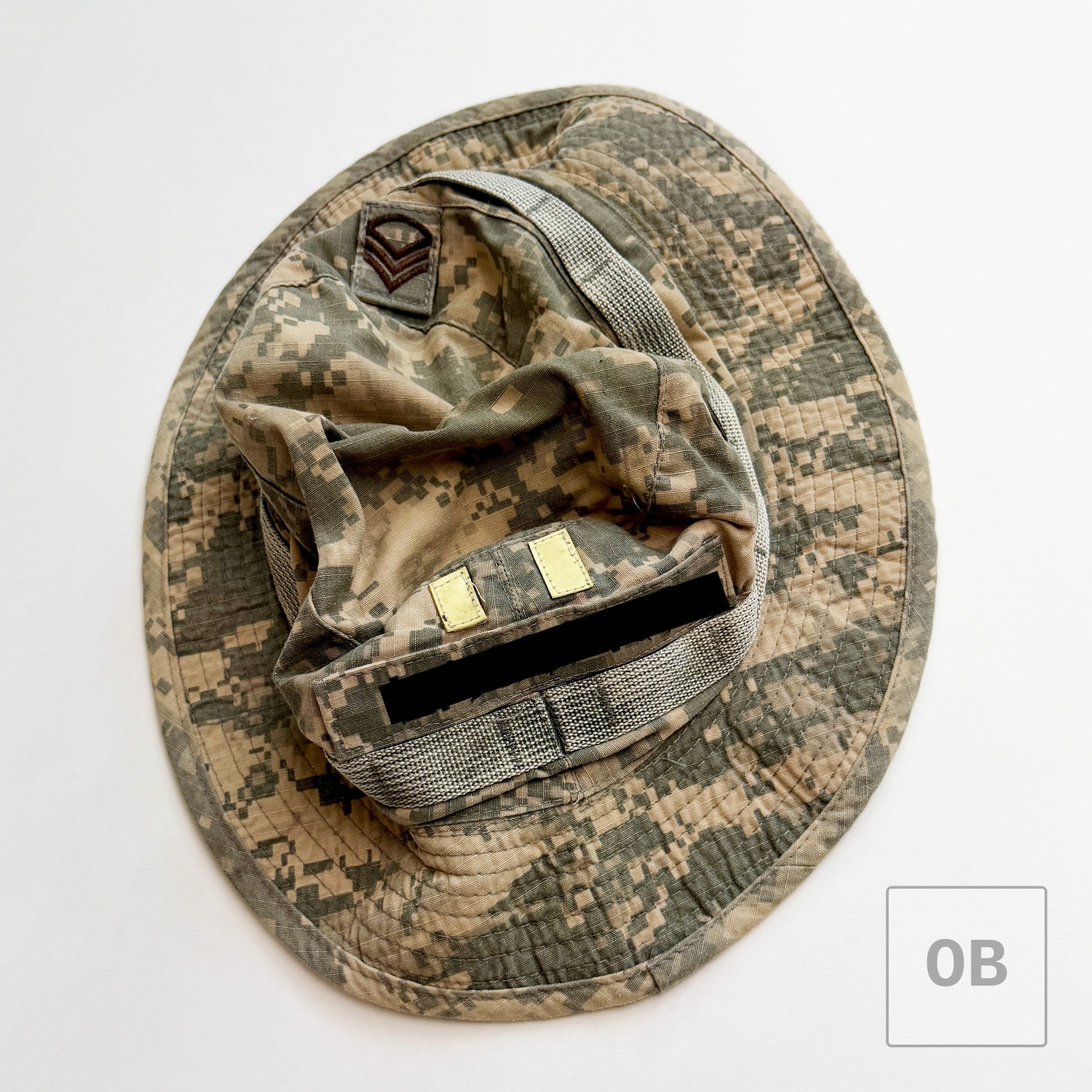 Exterior of the UCP boonie hat, showing an NCO chevron patch and redacted name tape.