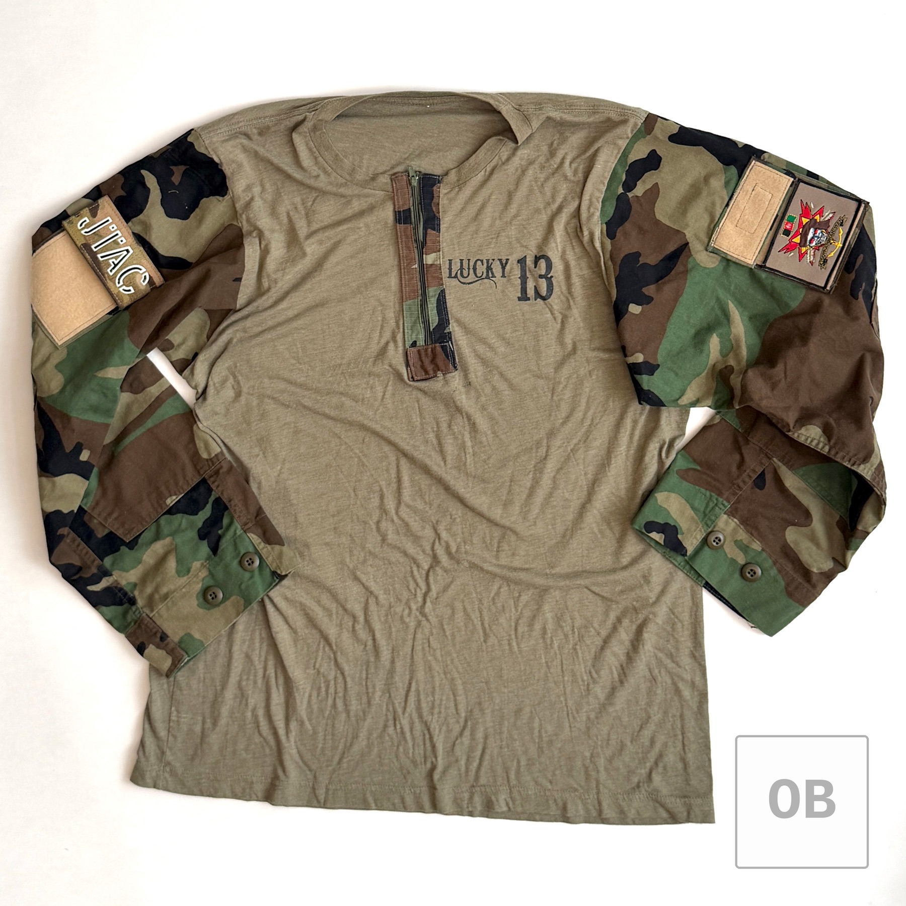 Back of the tailor-made combat top, printed with a skull gripping a V-42 knife and crossed raft paddles, and "ODA 7113."