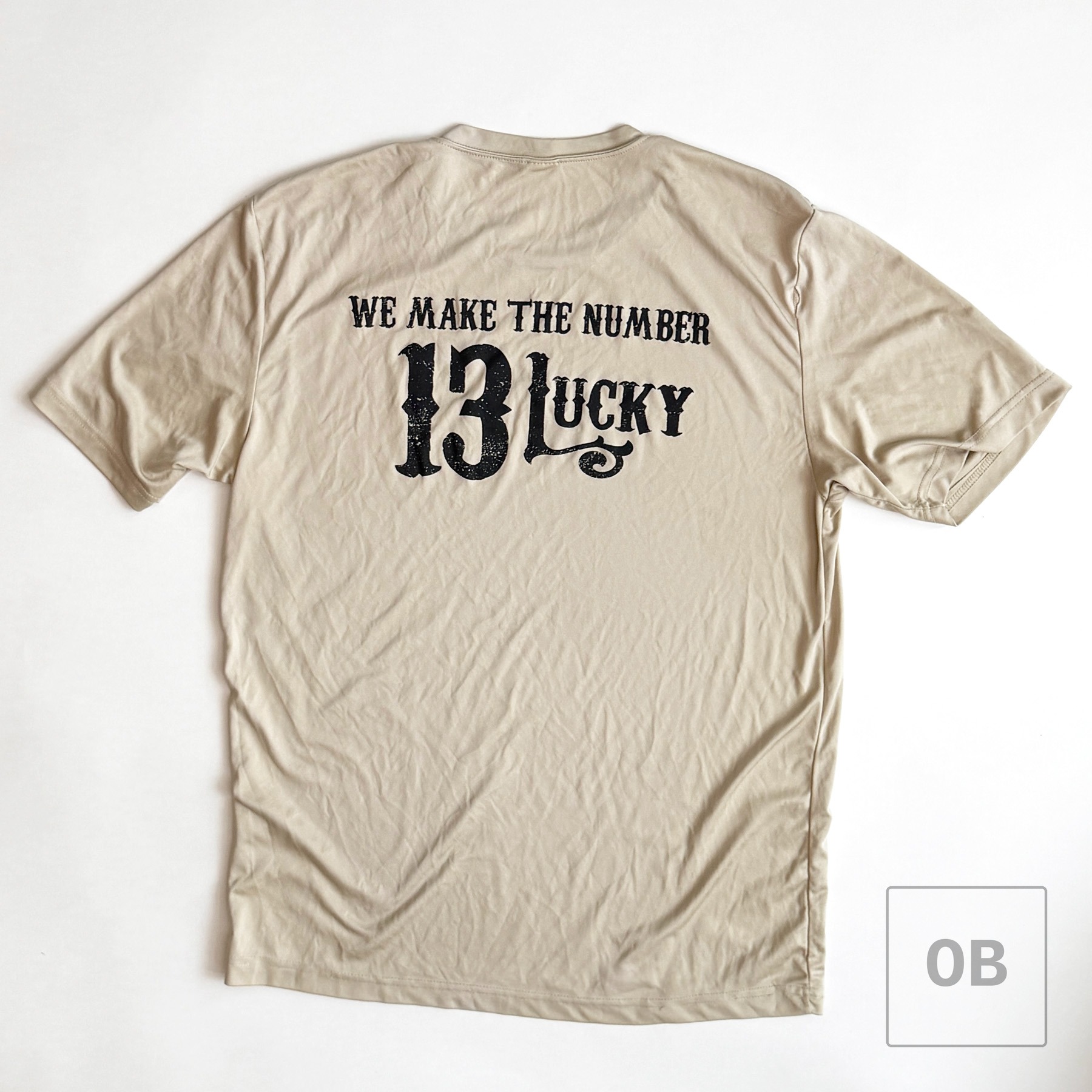 Back of the separate Lucky 13 ODA t-shirt, printed "We Make the Number 13 Lucky."