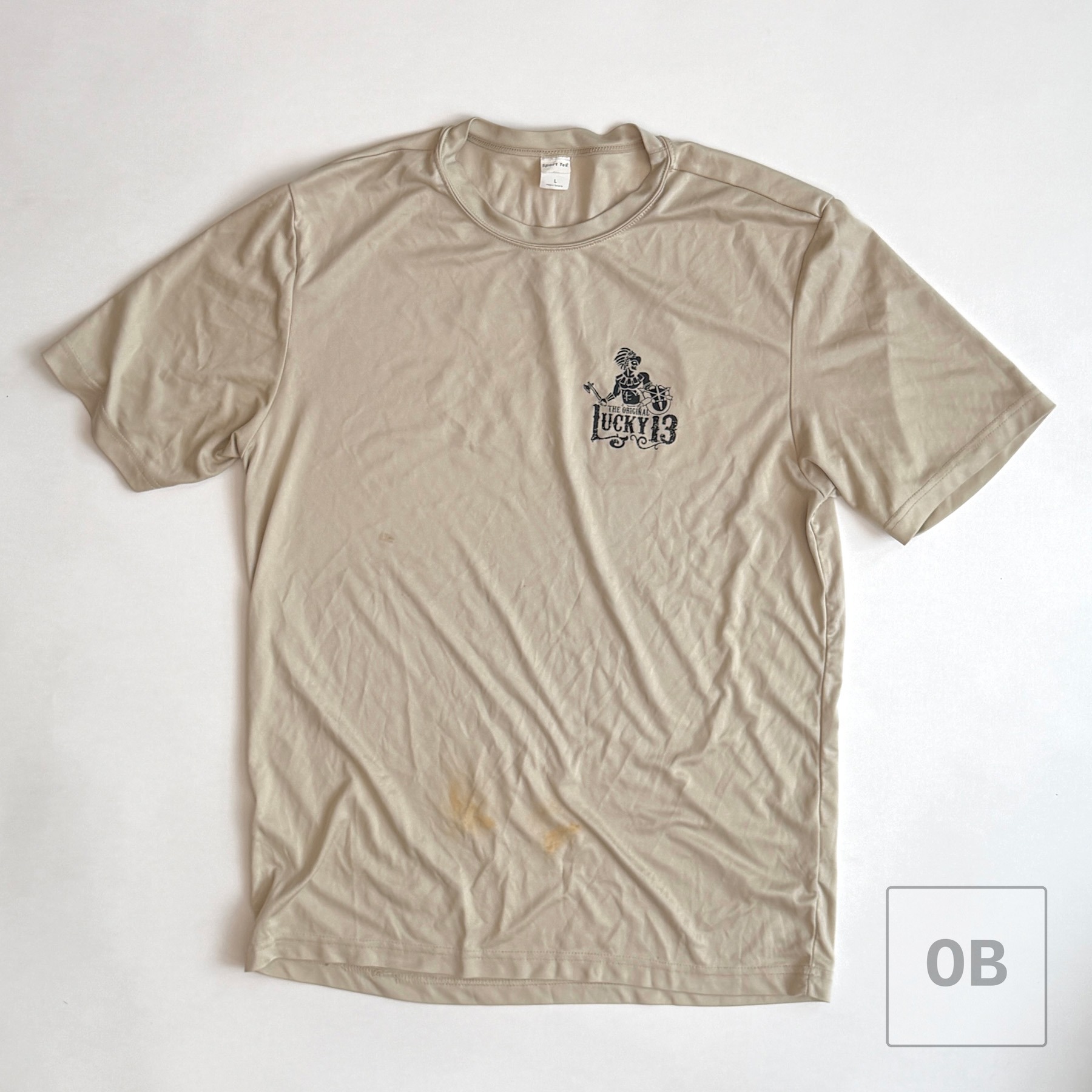 Separate tan Lucky 13 unit t-shirt, with a "Made in Tanzania" tag, included with the group.