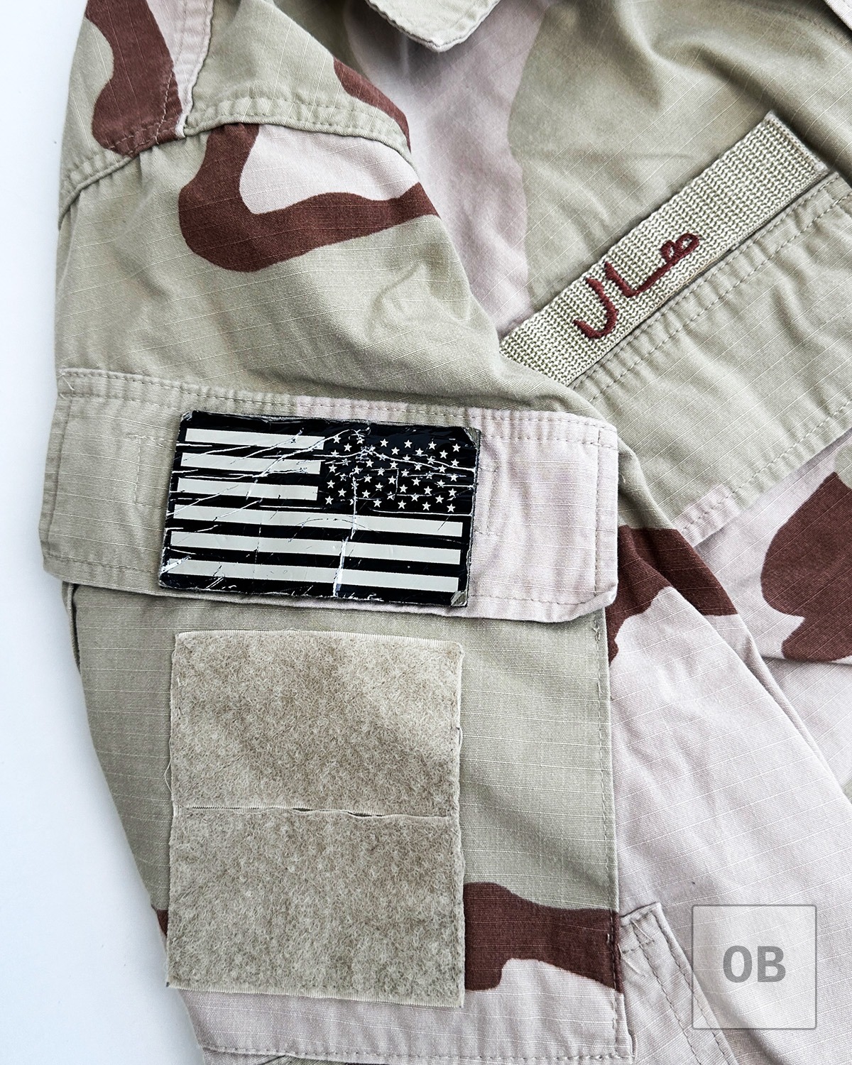 Subdued American flag patch on the left shoulder pocket, with hook-and-loop fastener below.
