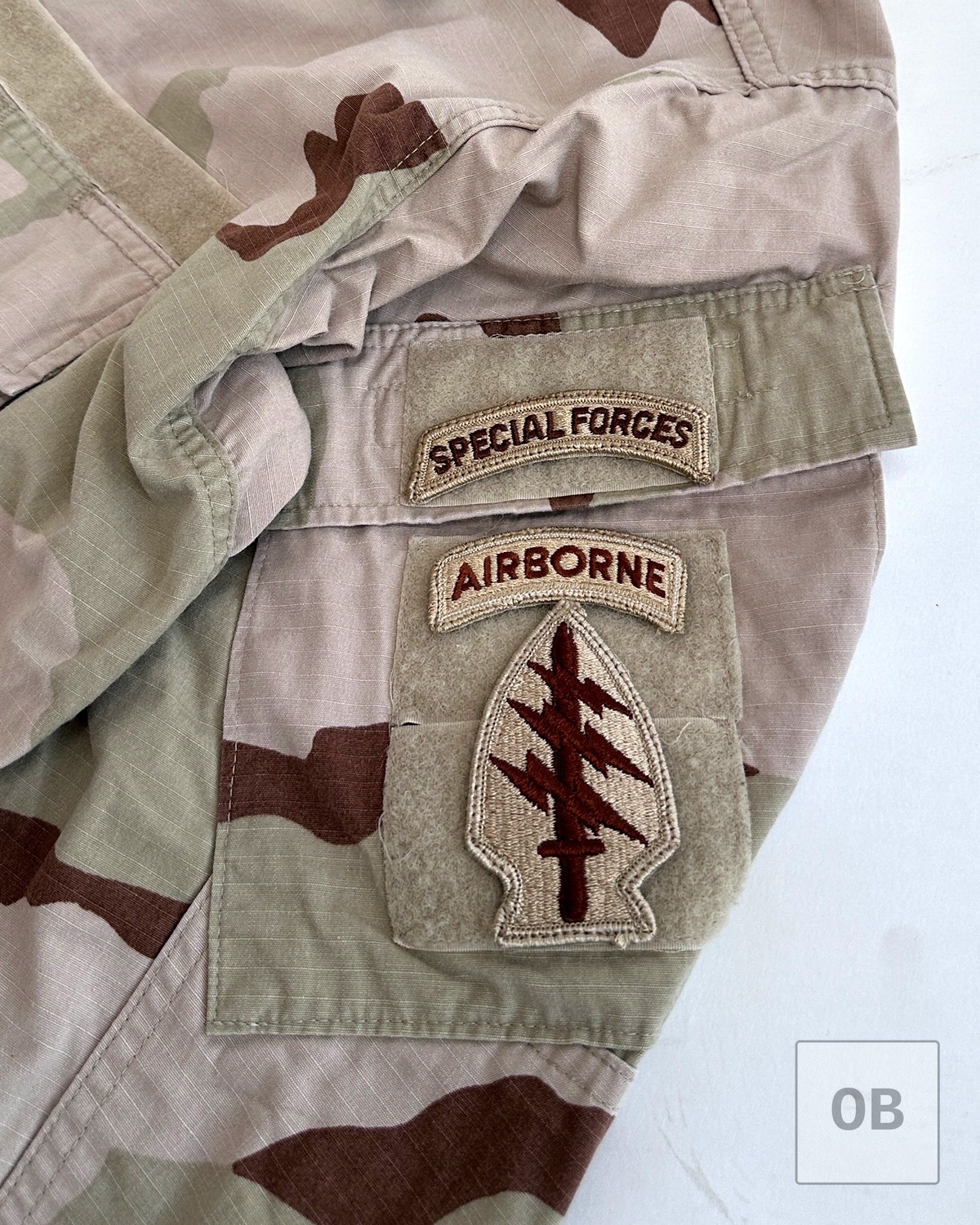 Special Forces tab, Airborne tab, and Special Forces Regimental insignia on the right shoulder pocket.