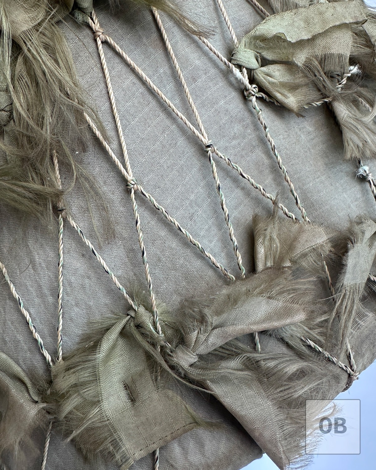 Fishnet camouflage showing differing cord on an early Viet Cong camouflage helmet.