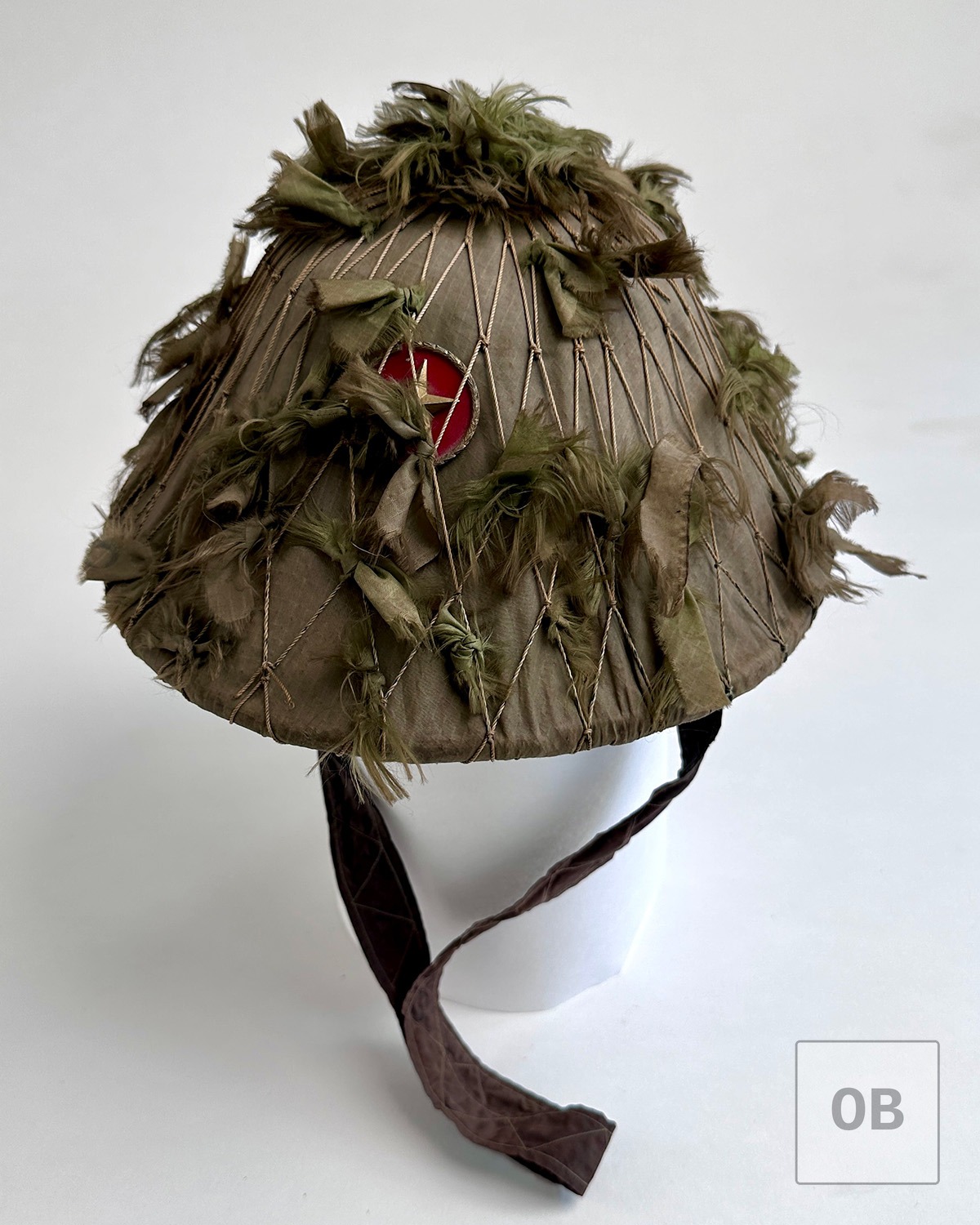 Three-quarter view of an early Viet Cong camouflage helmet.