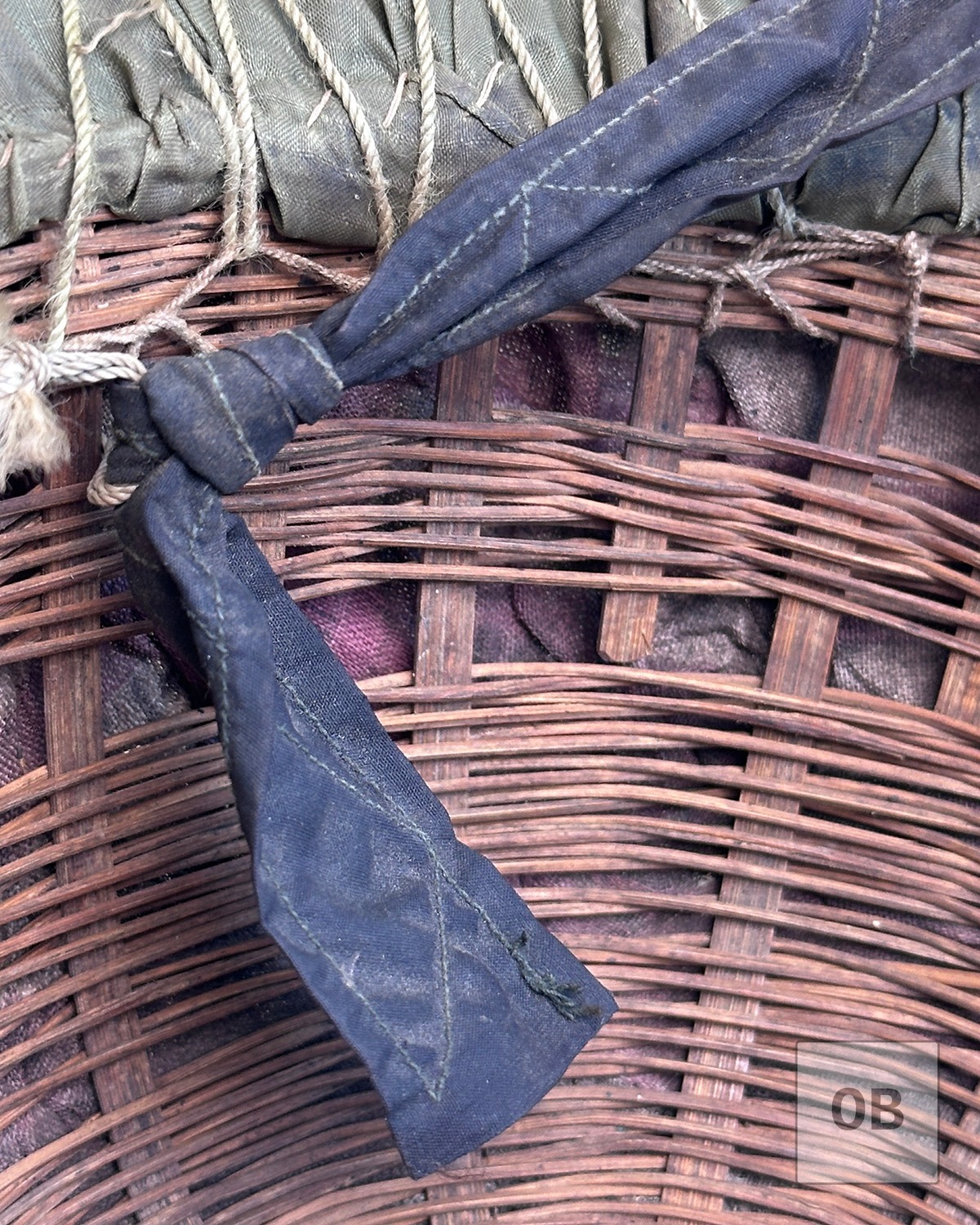 Woven textile between the parachute nylon cover and woven reed helmet shell.