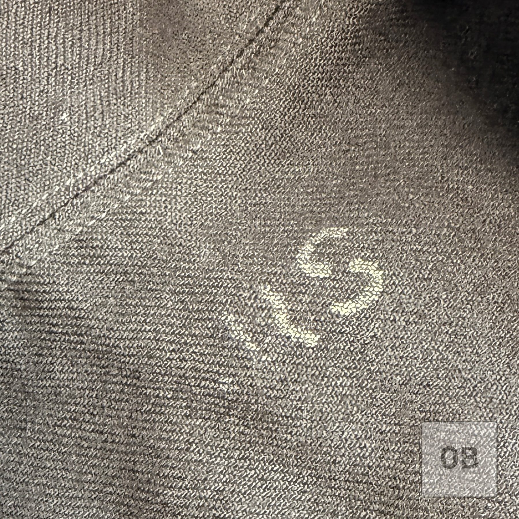 Initials GRS stenciled in white ink on SEAL Team 1 operator Gary R. Smith's wool dress blue jumper.