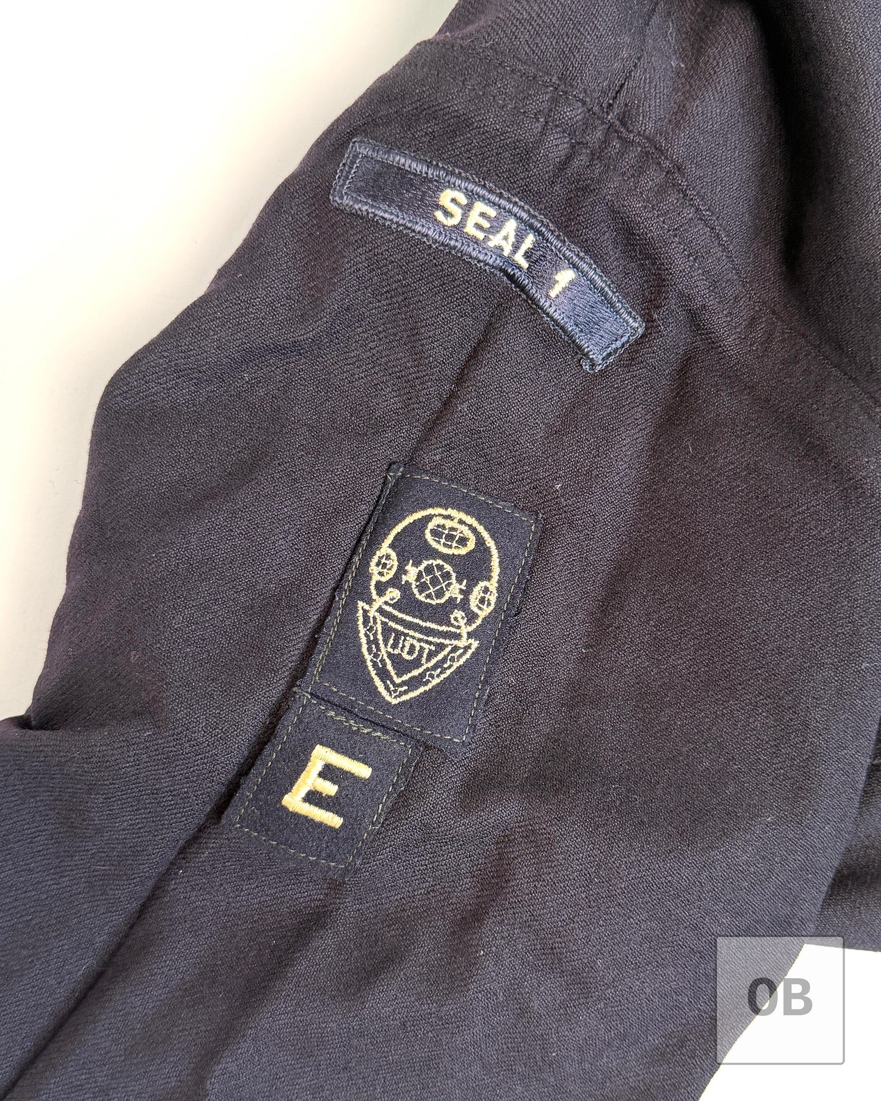 SEAL Team 1 shoulder scroll, UDT diving helmet patch and Battle Efficiency E patch on Gary R. Smith's Navy dress blue jumper.