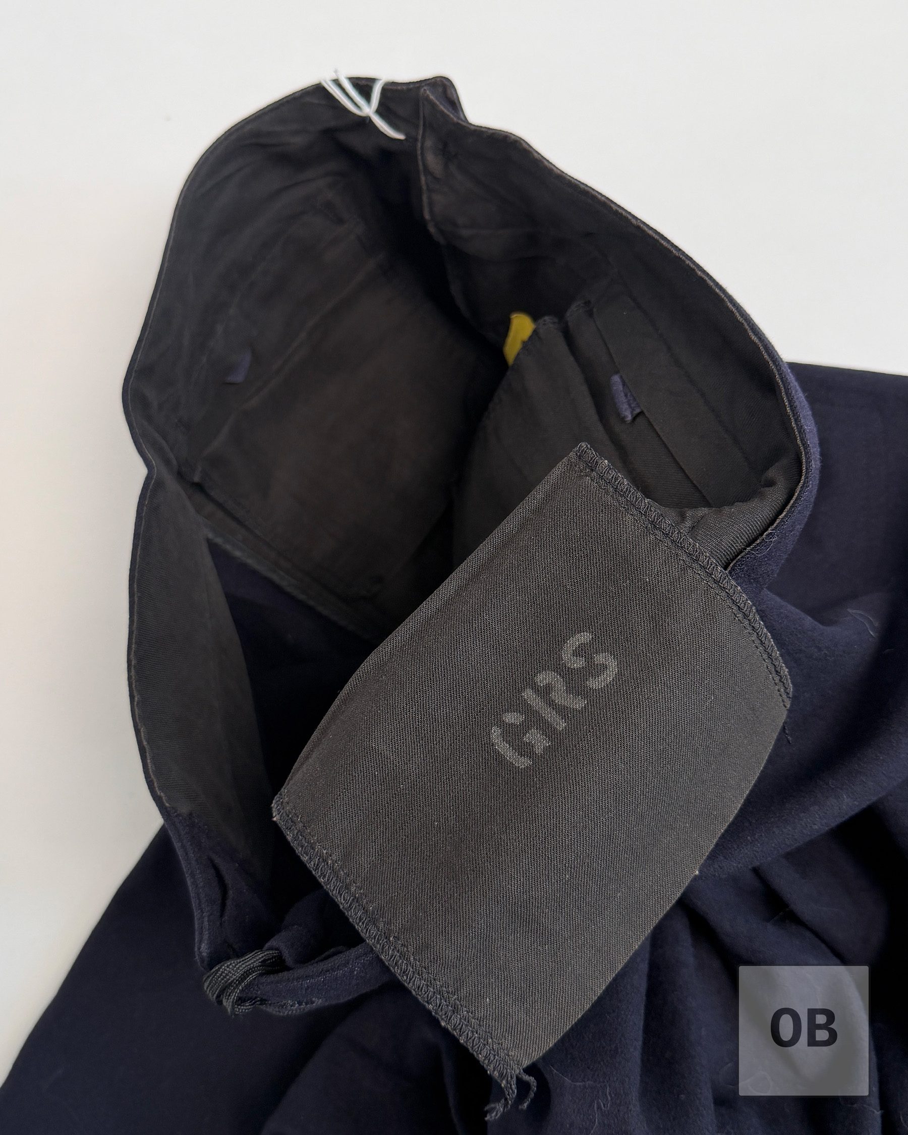 Interior waistband of SEAL Team 1 operator Gary R. Smith's dress blue trousers with GRS stenciled in white ink.