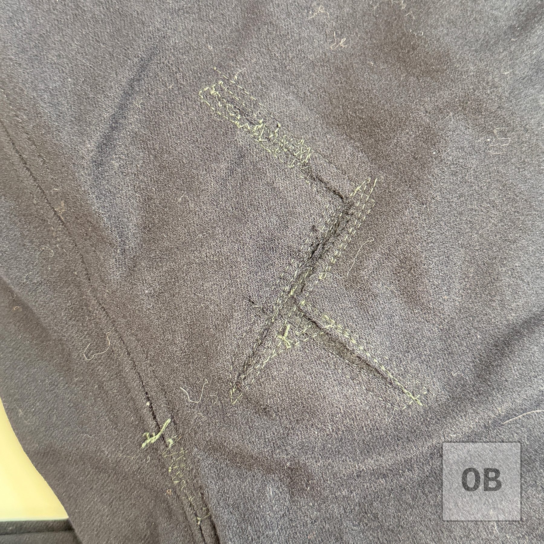 Significant hand-stitched repair to the seat of a SEAL Team 1 operator's wool dress blue trousers.