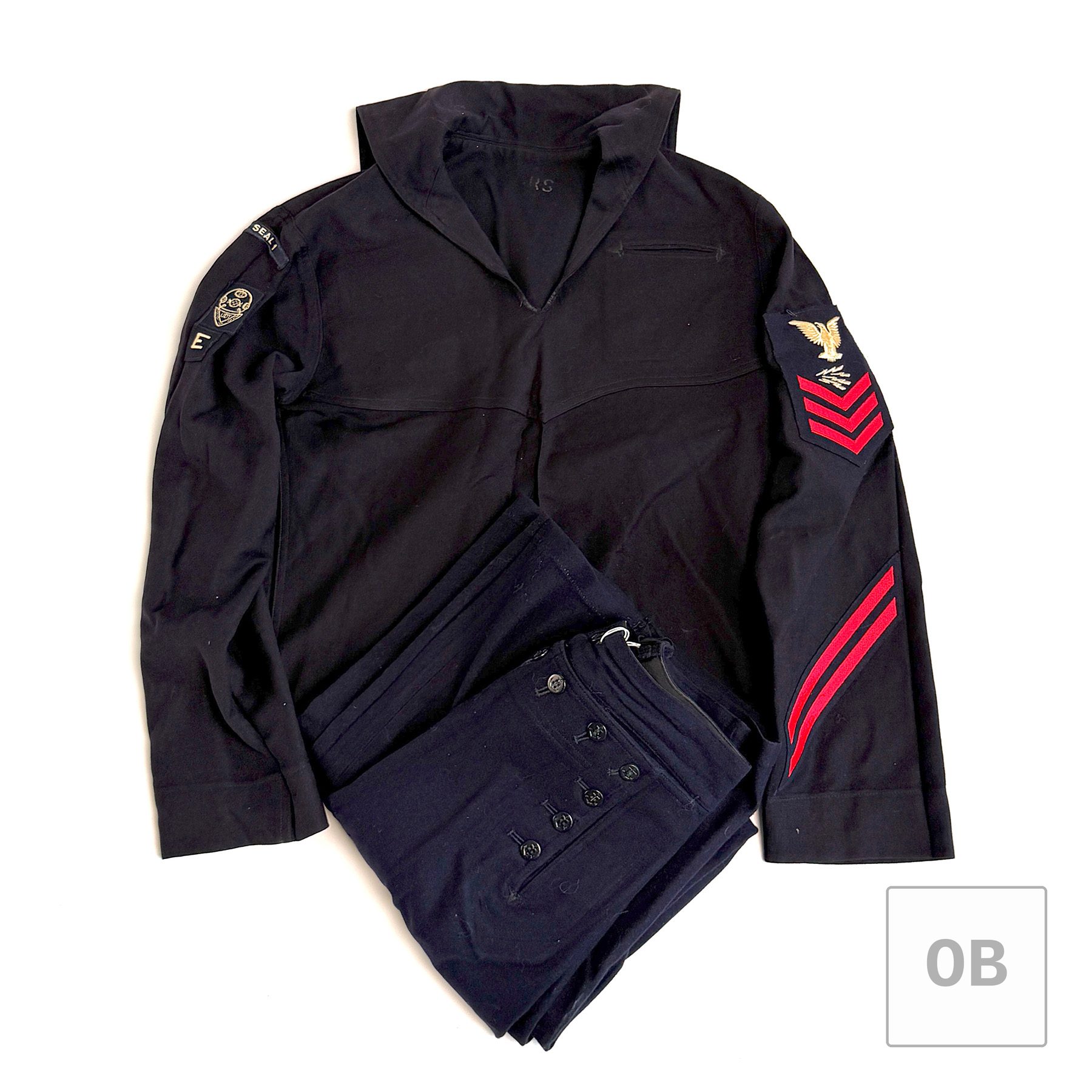Navy SEAL Team 1 wool dress blue jumper and trousers with a First Class Radioman (RM1) rating badge and two service stripes.