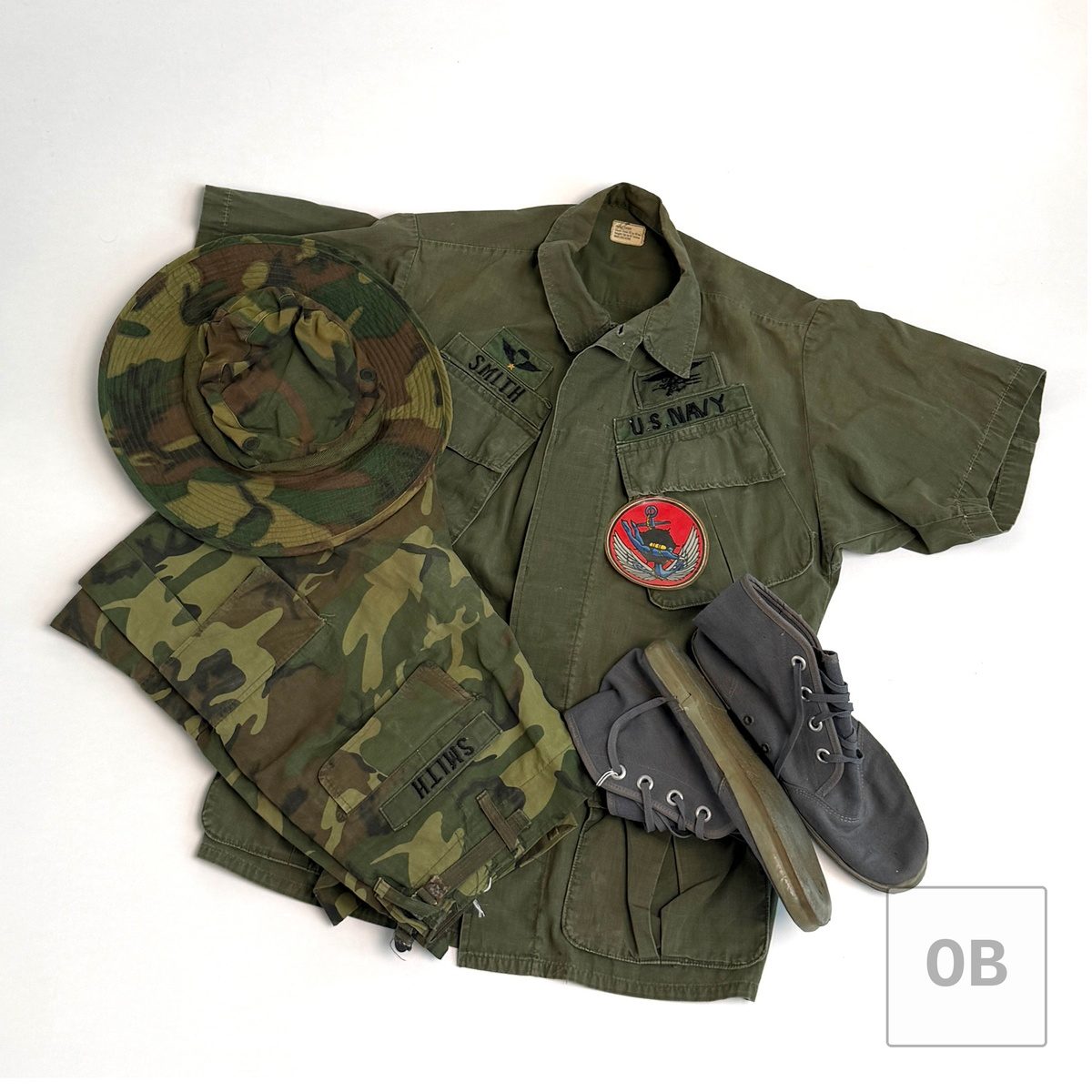 Vietnam War Navy SEAL Team 1 uniform group of Gary R. Smith: OD jungle jacket with SMITH and U.S. NAVY tapes, SEAL Trident and LDNN patch, ERDL camouflage trousers, ERDL boonie hat and UDT coral booties.