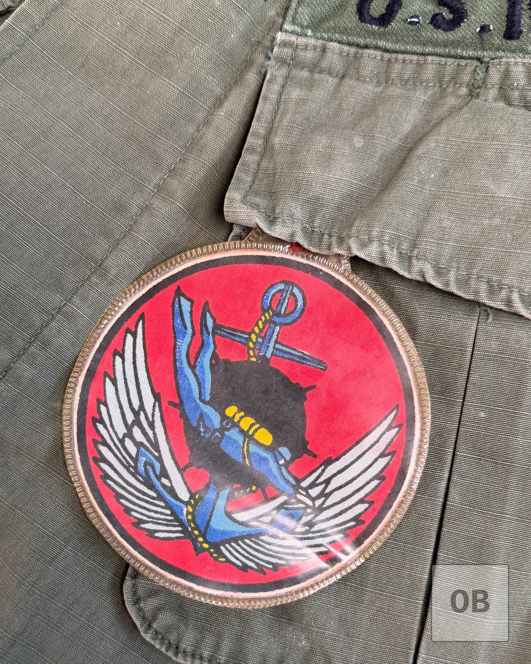 Vietnamese-made printed LDNN (South Vietnamese SEAL) patch in a plastic pocket hanger on a Navy SEAL Team 1 OD jungle jacket.