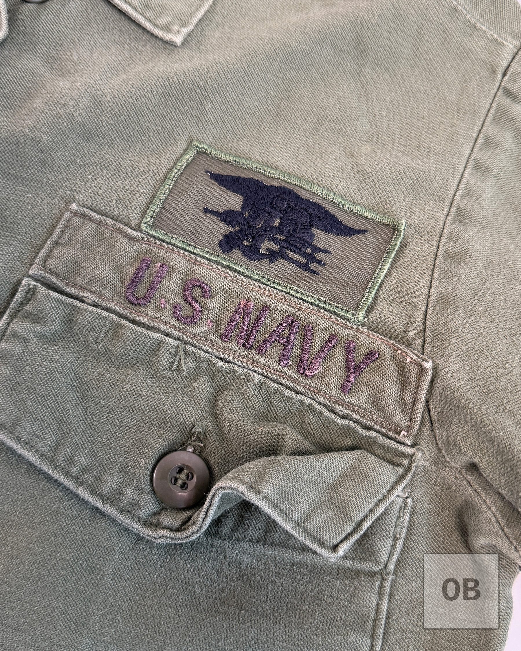 Navy SEAL Trident on poly-blend twill and a theater-made U.S. NAVY tape on a SEAL Team 1 OD utility shirt.