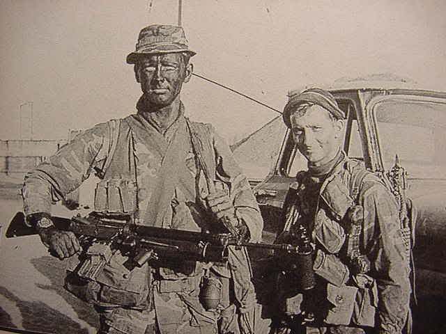 Period photograph of Navy SEAL Team 1 operator Gary R. Smith (left) with another SEAL in camouflage face paint in Vietnam.